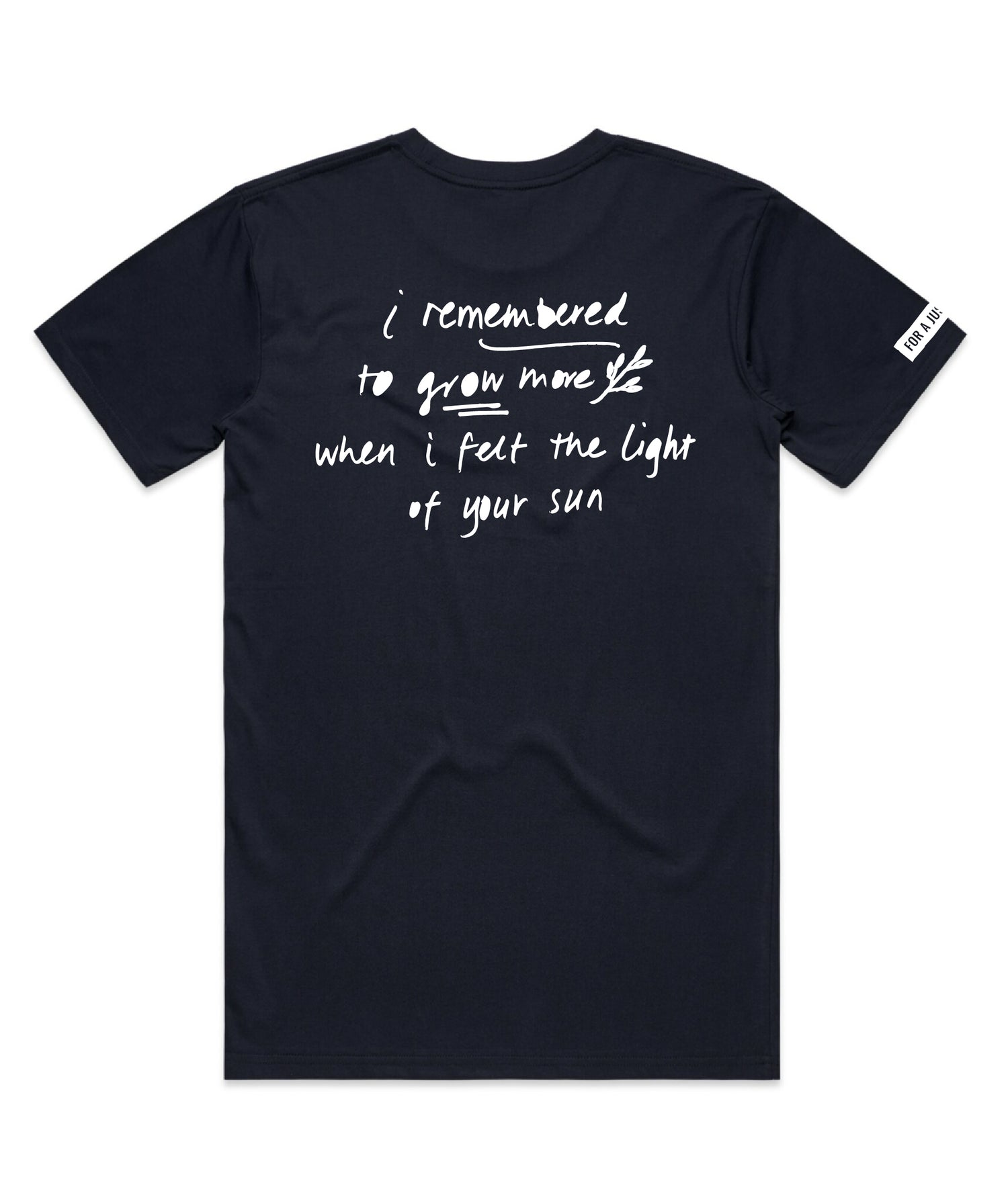 Kav Temperley wearing family domestic violence charity t shirt Flat lay of ink navy tshirt reading the words 'I remembered to grow more when I felt the light of your sun' in white